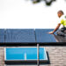 A worker installs solar panels on a home. (iStockphoto image)