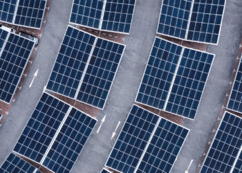 An aerial view of solar panels on a parking lot rooftop. (iStockphoto image)