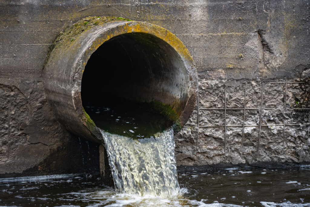 Dirty water flows from a pipe into a river. (iStockphoto image)