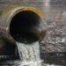 Dirty water flows from a pipe into a river. (iStockphoto image)