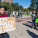 A demonstrator holds a sign at a climate protest in Denver. (Streetsblog Denver, CC BY 2.0, via Wikimedia Commons)
