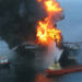 A Coast Guard rescue helicopter and crew document the fire aboard the mobile offshore drilling unit Deepwater Horizon on April 20, 2010. (US Coast Guard, via Wikimedia Commons)