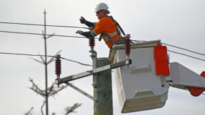 An utility worker fixes a power line. (iStock image)