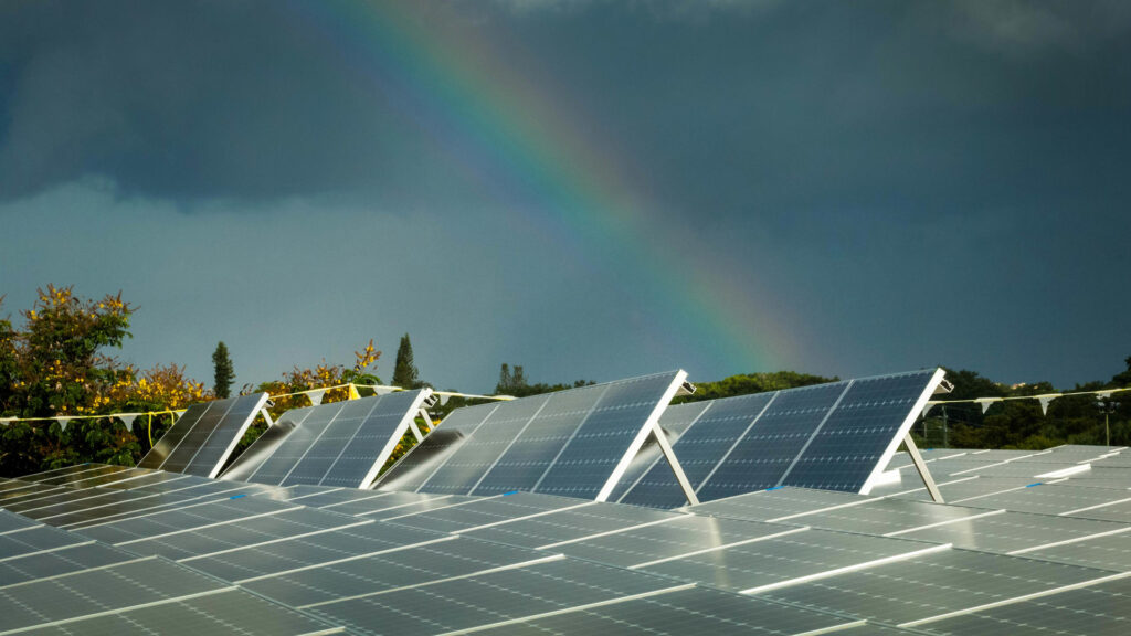 A rainbow over a rooftop solar array in Broward County. (Paul Krashefski/U.S. Department of Energy, via Wikimedia Commons)