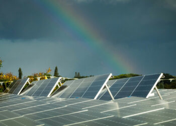 A rainbow over a rooftop solar array in Broward County. (Paul Krashefski/U.S. Department of Energy, via Wikimedia Commons)