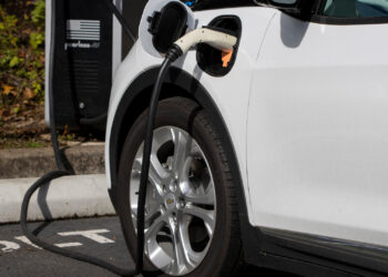 A Chevy Bolt EV electric car is seen charging at a public charging station. (iStock)