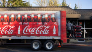 A Coca-Cola truck delivers plastic bottles of soda at a restaurant. (iStock image)