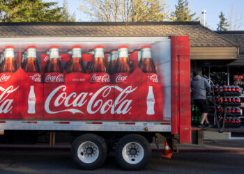 A Coca-Cola truck delivers plastic bottles of soda at a restaurant. (iStock image)