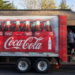 A Coca-Cola truck delivers plastic bottles of soda at a restaurant. (iStock image)