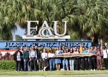 Florida Atlantic University’s Center for Environmental Studies hosts the annual International Water Professionals Program, which brings graduate students from the IHE Delft Institute for Water Education to South Florida. Here they pose with a Burmese python skin and head)used in one of their demonstrations. (Submitted photo)