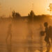Children get relief from a heat wave in the jets of a fountain. (iStock image)