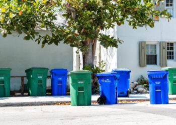 Trash cans and recycling bins line a street in Key West. (iStock image)