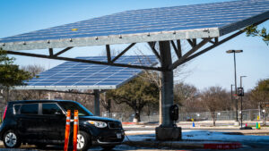 An electric vehicle charging by solar panels (iStock image)