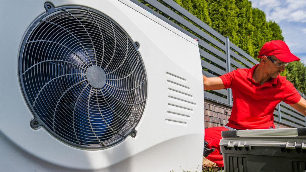 A worker installs a heat pump (iStock image)