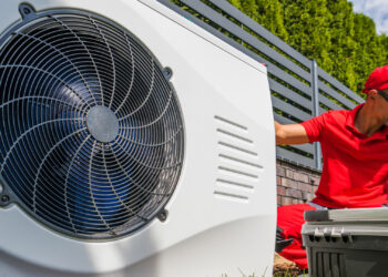 A worker installs a heat pump (iStock image)