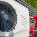 A worker installs a heat pump (iStock image)