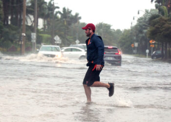 A man jogs through flooded roads in the Palm Beach area as Hurricane Nicole nears the Florida coast. (iStock image)