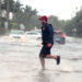 A man jogs through flooded roads in the Palm Beach area as Hurricane Nicole nears the Florida coast. (iStock image)