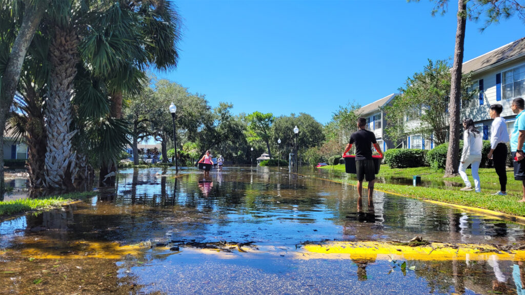 Hurricane Ian flooding victims carrying their belongings in Orlando (iStock image)