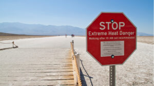 A sign warms of extreme heat warning in Death Valley, California. (Graeme Maclean, CC BY 2.0, via Wikimedia Commons)