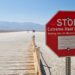 A sign warms of extreme heat warning in Death Valley, California. (Graeme Maclean, CC BY 2.0, via Wikimedia Commons)