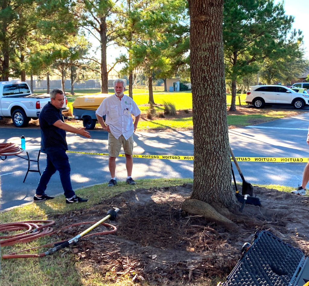 Dr. Andrew Koeser, UF/IFAS associate professor of environmental horticulture, demonstrates a tree root defect. (Photo courtesy of Deb Hilbert)