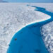 Richard Bates and Alun Hubbard kayak a meltwater stream on Greenland’s Petermann Glacier, towing an ice radar that reveals it’s riddled with fractures. (Nick Cobbing)