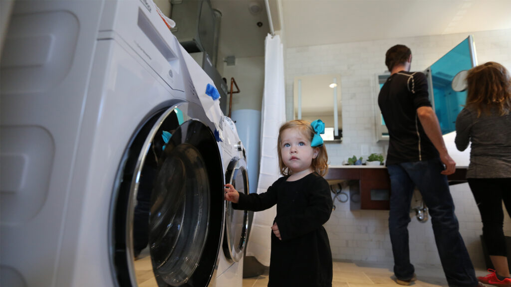 A future consumer checks out highly efficient appliances on display at the U.S. Department of Energy Solar Decathlon. (Credit: John De La Rosa/U.S. Department of Energy Solar Decathlon)