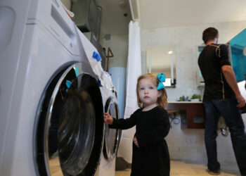 A future consumer checks out highly efficient appliances on display at the U.S. Department of Energy Solar Decathlon. (Credit: John De La Rosa/U.S. Department of Energy Solar Decathlon)