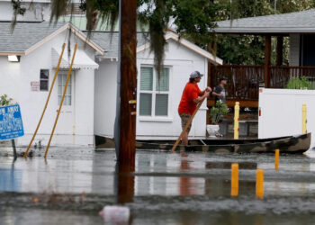 A person canoes through flooded streets in Tarpon Springs after Hurricane Idalia passed offshore on Aug. 30. (Joe Raedle/Getty Images via Grist)