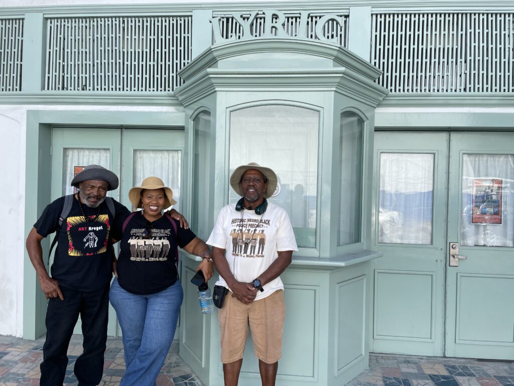 From left: Michael Clarkson, a local resident, Nicole Crooks of Catalyst Miami and Keith Ivory, a local historian, gather in front of the historical Lyric Theater. (Amy Green/Inside Climate News)