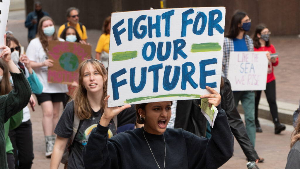 Youth people participate in a climate protest. (Mark Dixon, CC BY 2.0, via Wikimedia Commons)