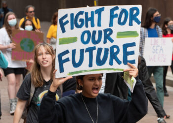 Young people participate in a climate protest. (Mark Dixon, CC BY 2.0, via Wikimedia Commons)
