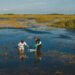 FIU aquatic ecologist Evelyn Gaiser and graduate student Samantha Hormiga take water samples. (FIU News)