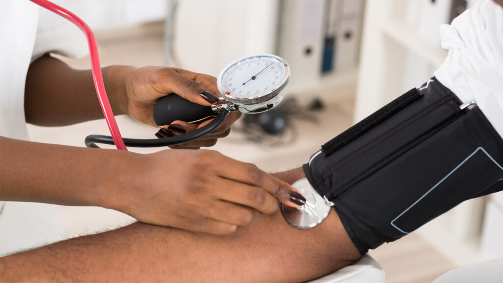 A doctor measures a patient's blood pressure (iStock photo)