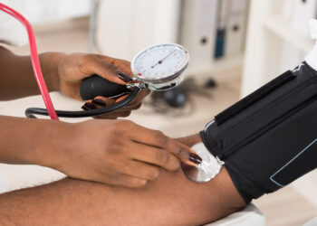 A doctor measures a patient's blood pressure (iStock photo)