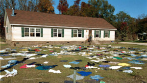 The floodwaters of Hurricane Floyd in 1999 covered almost the entire town of Princeville, N.C. Here, clothing and possessions which might be salvaged are dried and aired out in the sun. (Dave Gatley/FEMA, Public domain, via Wikimedia Commons)