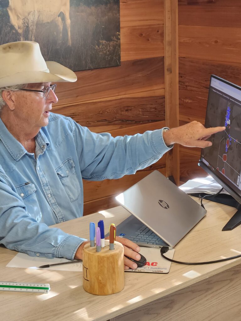 Jim Strickland, manager of Blackbeard’s Ranch, points out cattle locations on his computer. (Brad Buck, UF/IFAS Communications)