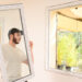 A worker installs an energy-efficient window. (iStock image)