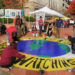 Members of the Sunrise Movement join in painting a mural reminding passers-by that “the earth is watching” before a climate protest in California. (Fabrice Florin, CC-BY-SA 3.0, via flickr)