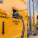 An electric school bus plugged in at a charging station (iStock image)