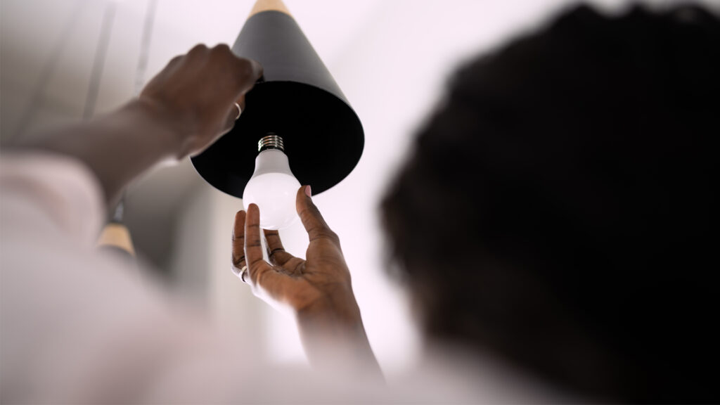 An energy-efficient lightbulb is installed. (iStock image)