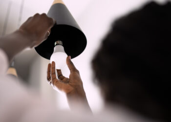 An energy-efficient lightbulb is installed. (iStock image)