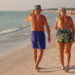 An elderly couple walks down the beach in Florida (iStock image)