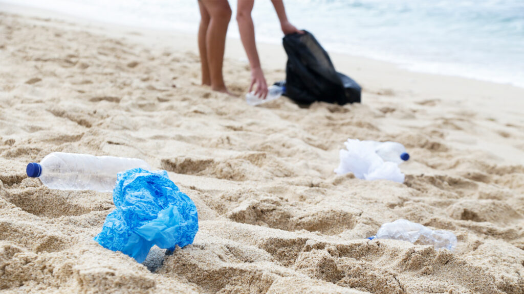 Plastic waste being picked up on a beach (iStock image)
