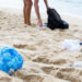 Plastic waste being picked up on a beach (iStock image)