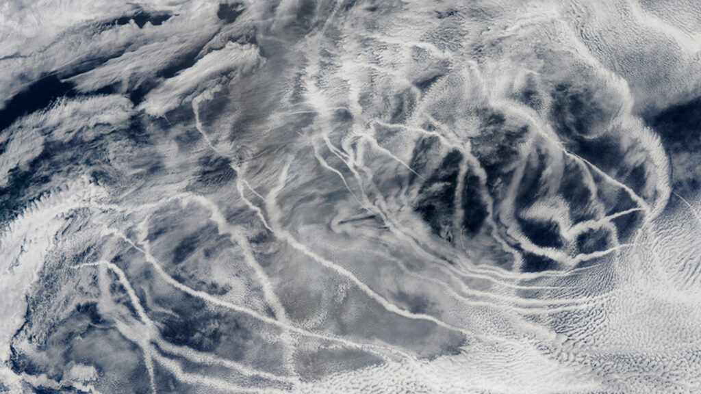"Ship tracks" above the northern Pacific Ocean show up as long lines on this image taken by the Moderate Resolution Imaging Spectroradiometer onboard NASA’s Aqua satellite in 2010. These patterns are produced when fine particles from ship exhaust float into a moist layer of atmosphere. The particles seed new clouds or attract water from existing cloud particles. (Image by: NASA/GSFC/Jeff Schmaltz/MODIS Land Rapid Response Team)