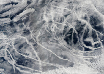 "Ship tracks" above the northern Pacific Ocean show up as long lines on this image taken by the Moderate Resolution Imaging Spectroradiometer onboard NASA’s Aqua satellite in 2010. These patterns are produced when fine particles from ship exhaust float into a moist layer of atmosphere. The particles seed new clouds or attract water from existing cloud particles. (Image by: NASA/GSFC/Jeff Schmaltz/MODIS Land Rapid Response Team)