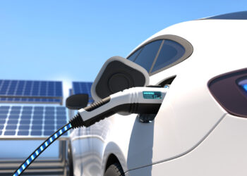 A 3D illustration of an electric car charging and solar panels (iStock image)