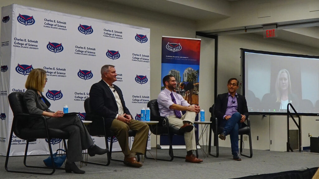 Participants in a panel discussion at Florida Atlantic University on the Florida Wildlife Corridor, from left: Valery Forbes, dean of the FAU Charles E. Schmidt College of Science; Charles “Buck” MacLaughlin, range operations officer at Avon Park Air Force Range; Joshua Daskin, director of conservation at Archbold Biological Station; Colin Polsky, founding director of the FAU School of Environmental, Coastal, and Ocean Sustainability (ECOS); and state Rep. Lindsay Cross, D-St. Petersburg (over video stream). (Photo by Naomi von Bose, FAU CES)